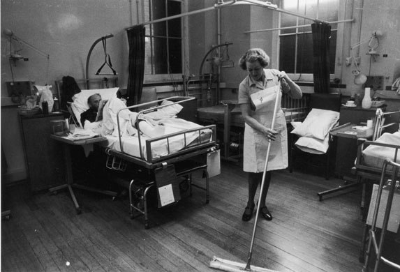 Hospital wards: A nurse sweeps the floor of a ward at St Mary's Hospital, Paddington