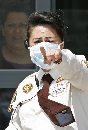 International Swine Flu: A guard wearing a mask outside the Hospital General in Almansa, Spain