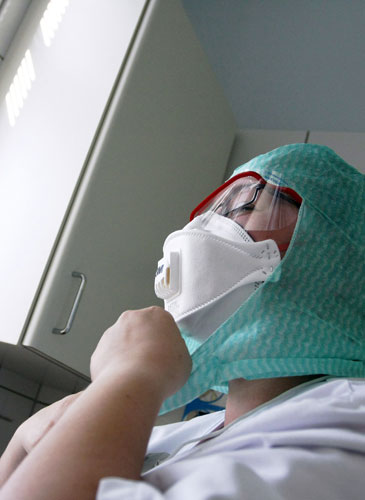 International Swine Flu: A nurse wears protective clothing at Aurora Hospital in Helsinki