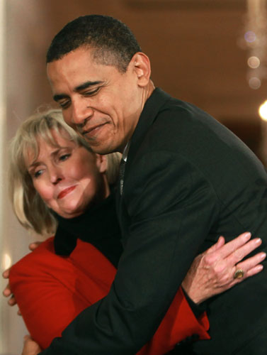 obama 100 days : Barack Obama hugs Lilly Ledbetter before signing the Fair Pay Act