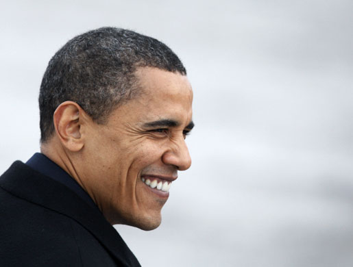 obama 100 days : Obama shows increasing grey hair as boards Air Force One 