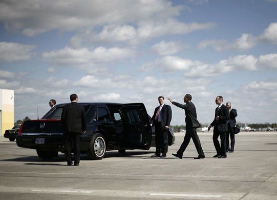 obama 100 days : Obama waves as he walks to his limousine at MacDill Air Force Base