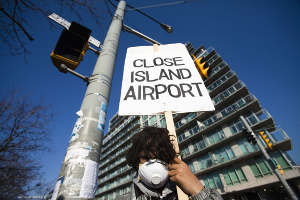 28 April 2009: Canada: A boy holds protests against the expansion of the City Airport