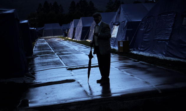 28 April 2009: L'Aquila, Italy: An elderly man walks amid the tents at the refugee camp