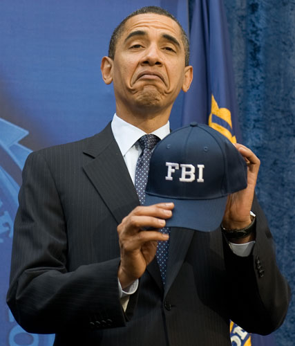 Obama 100 days: US President Barack Obama reacts to an FBI hat given to him.