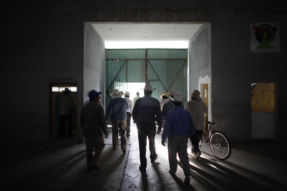 Swine flu La Gloria: Local farmers leave a sports centre after a meeting in La Gloria village.
