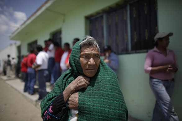 Swine flu La Gloria: A woman stands outside the home of a child who survived the swine flu.