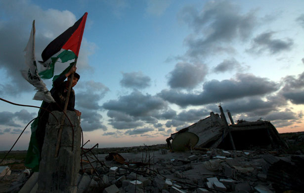 29 April 2009: Gaza Strip, Gaza City: Children play on demolished houses
