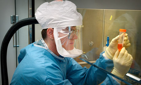 Dr. Terrence Tumpey examines specimens of the 1918 pandemic influenza virus in the US