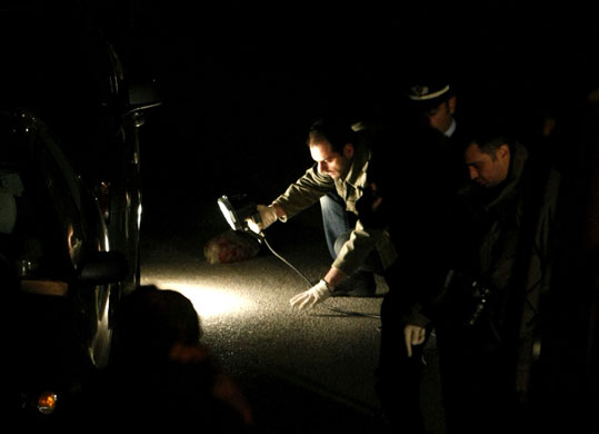 24 hours in pictures: A police investigator looks into the murder of policemen in Athens