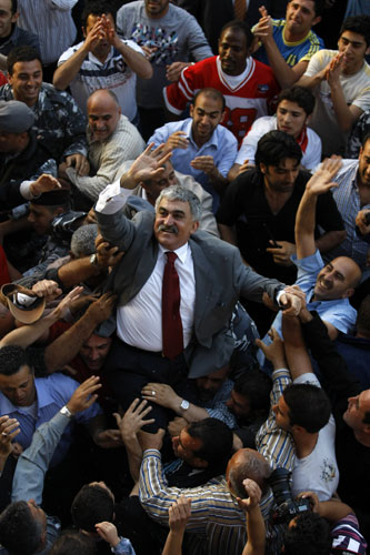 30 April 2009: Beirut, Lebanon: Men carry former domestic security chief Ali Hajj