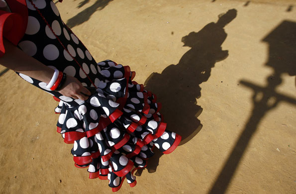 30 April 2009: Seville, Spain: A woman wearing a Sevillana dress takes part in a fair