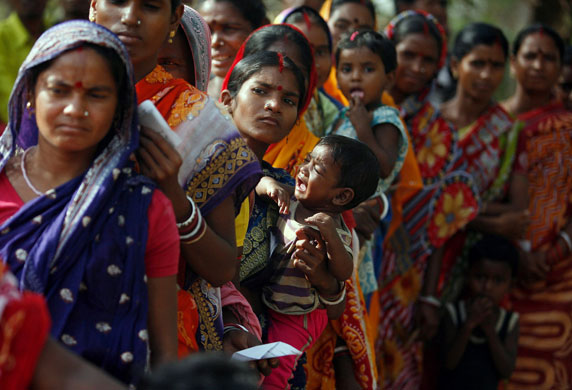 30 April 2009: Lalgarh, India: A voter stands in a queue to cast her ballot