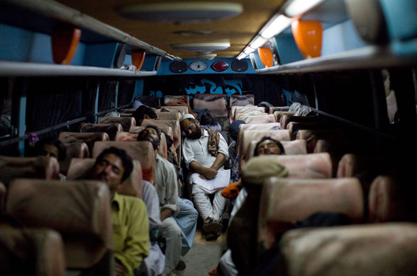 30 April 2009: Peshawar, Pakistan: People sleep on a public bus