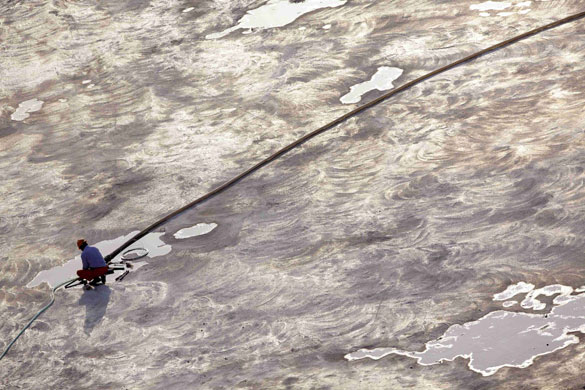 30 April 2009: Shanghai, China: A migrant labourer works at a construction site