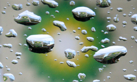 A sign at a BP petrol station is reflected in raindrops in London.