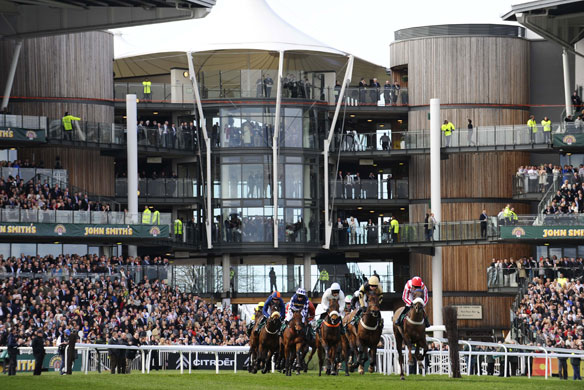 Grand National: Runners in the 1st race pass by the stands