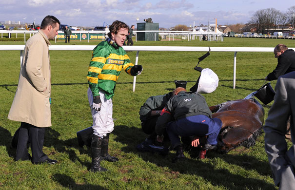 Grand National: Tony McCoy throws away his helmet