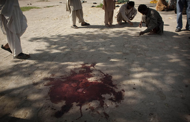 Pakistan suicide attack: Police officers collect evidence