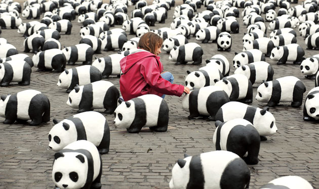 5 April 2009: Nantes, France: A girl plays with paper mache pandas during a WWF protest