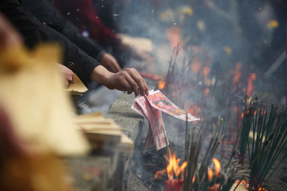 5 April 2009: Beichuan, China: Mourners burn incense and offerings at an impromptu shrine