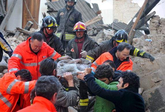 Italy earthquake: Rescue teams retrieve a person from a building