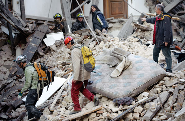 Italy earthquake: Rescuers search for trapped people under the ruins of a collapsed house