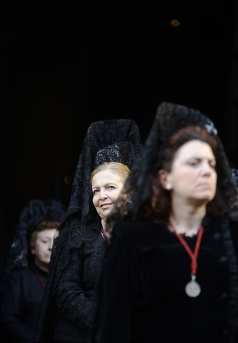 Penitents in Spain: Penitents take part in a Palm Sunday procession