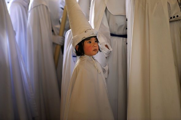 Penitents in Spain: A child during the La Paz brotherhood procession in Seville