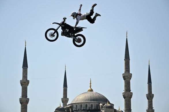 Sport: 24 hours: A German motocross biker performs in front of the Blue Mosque in Istanbul 