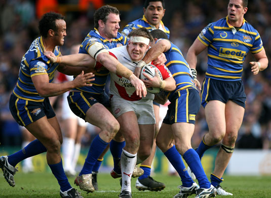 Sport: 24 hours: St. Helens' Bryn Hargreaves is tackled by the Leeds Rhinos