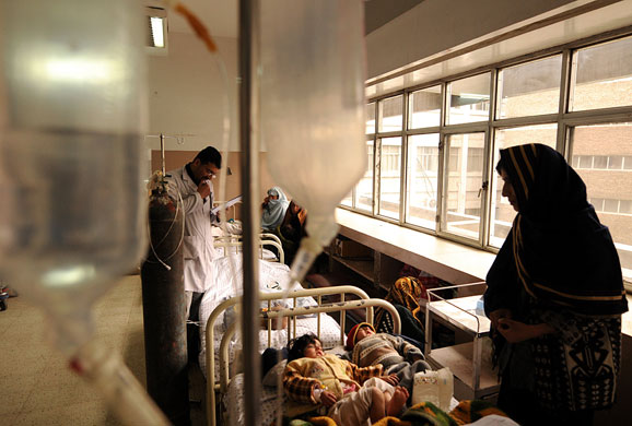 6 April 2009: Kabul, Afghanistan: A doctor examines a young girl at a hospital