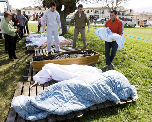 L'Aquila earthquake: Coroner carries the body of an infant