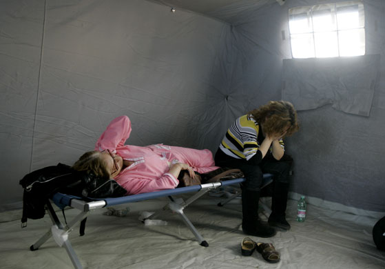 L'Aquila earthquake: Two women take a rest in a tent camp in L'Aquila