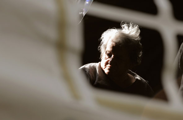 L'Aquila earthquake: A woman rests at a tent camp in Aquila