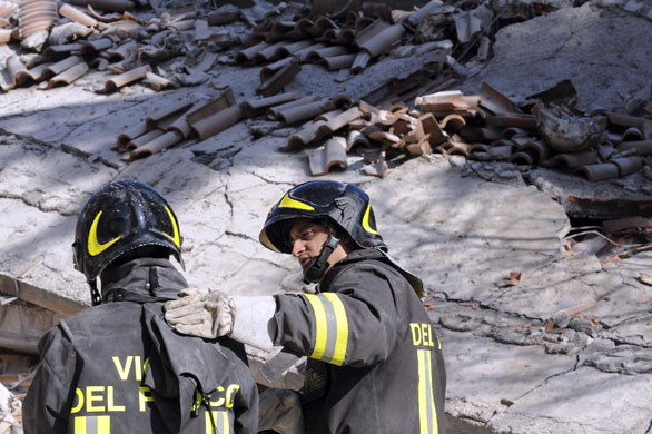 L'Aquila earthquake: A firefighter comforts a colleague in Aquila