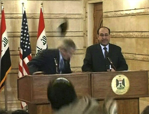 Visits to Iraq: A man throws a shoe at George Bush during a news conference