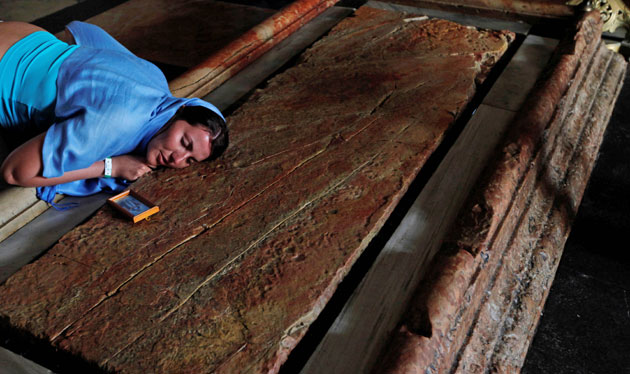 24 hours in pictures: A Christian worshipper prays over the Stone of Anointment