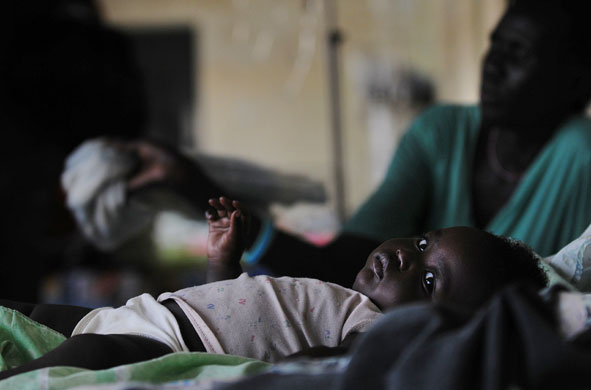 24 hours in pictures: A malaria-infected baby lays in a bed in a malaria ward Sudan