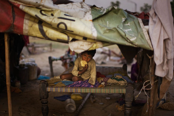 24 Hours in pictures: A young boy in his home in a shanty village in Faridabad