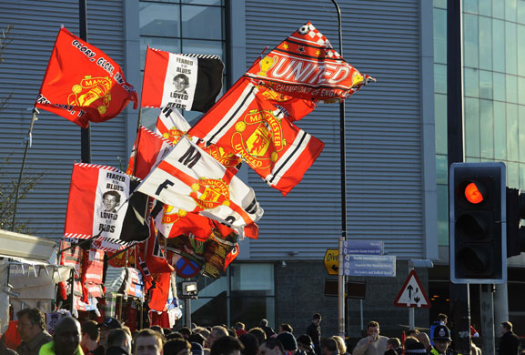 Manchester United v Porto: Flags flying in the stiff breeze blowing around Old Trafford
