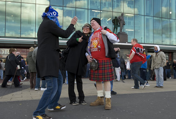 Manchester United v Porto: Porto fans take photos of a United fan in his kilt
