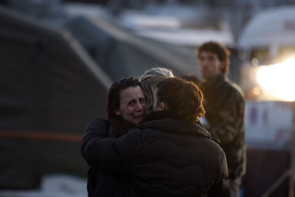 Earthquake aftershock: A woman reacts after an aftershock, at a makeshift camp in L'Aquila