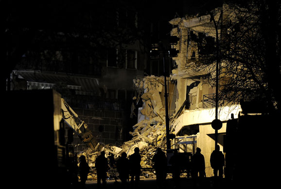Earthquake aftershock: Rescuers work  to recover victims from inside a building in L'Aquila
