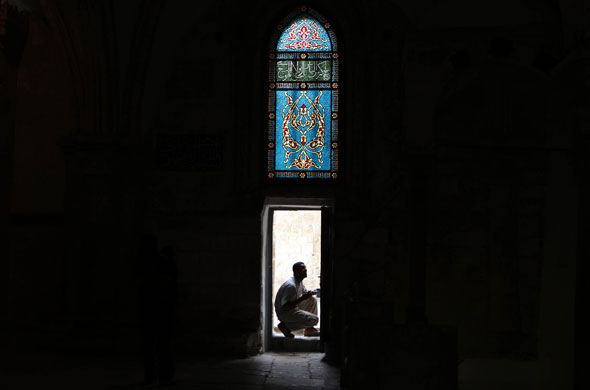 8 April 2009: Jerusalem, Israel: A worker paints the door of the Cenacle