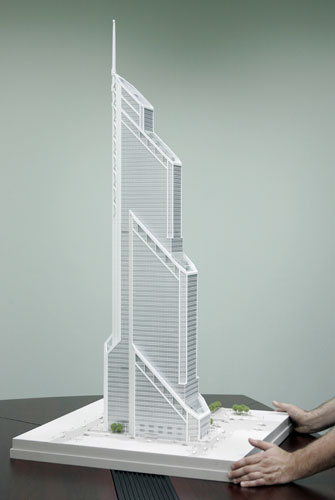 Green skyscrapers: A man places a model of US architect Frank Williams' Mercury City Tower