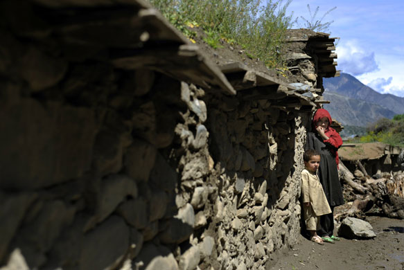 24 hours in pictures: Afghan children stand by a door in Kunar