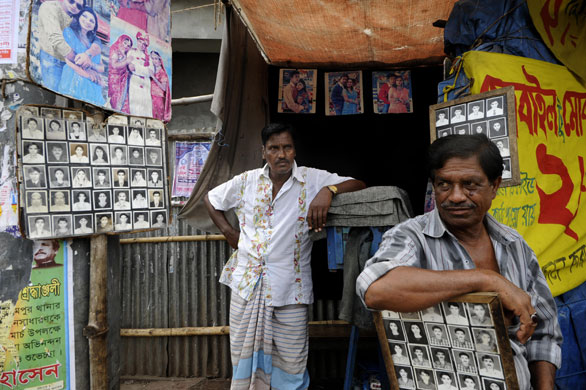 24 hours in pictures: Bangladeshi portrait photographers wait for customers