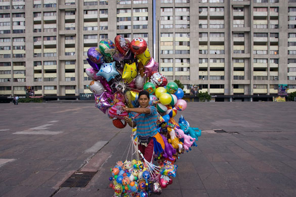 Mexico swine flu: A vendor of balloons stands in an almost empty explanade.