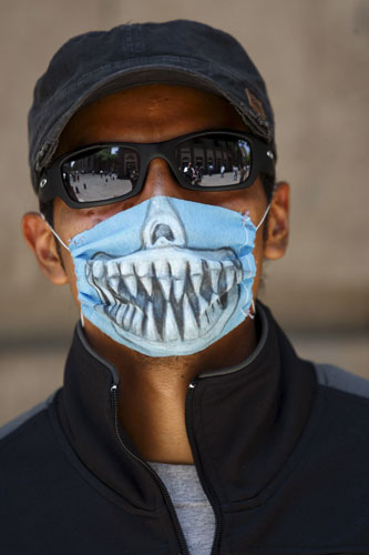 Swine flu face masks: A man wears a decorated face mask against swine flu in Mexico